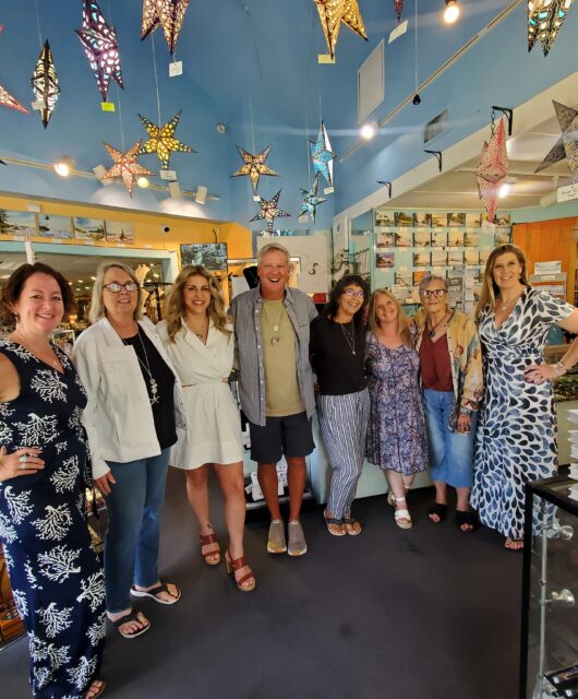 Group photo of Holly, Dan, Kate, and others at a past trunk show of Dune Jewelry at Suncatchers' Dream on Sanibel Island.