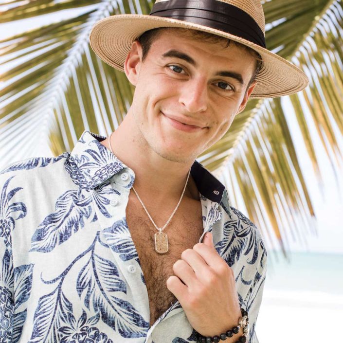 Male model wearing the Sterling Silver Travel Tag, one of the best Father's Day Gifts for stylish dads.