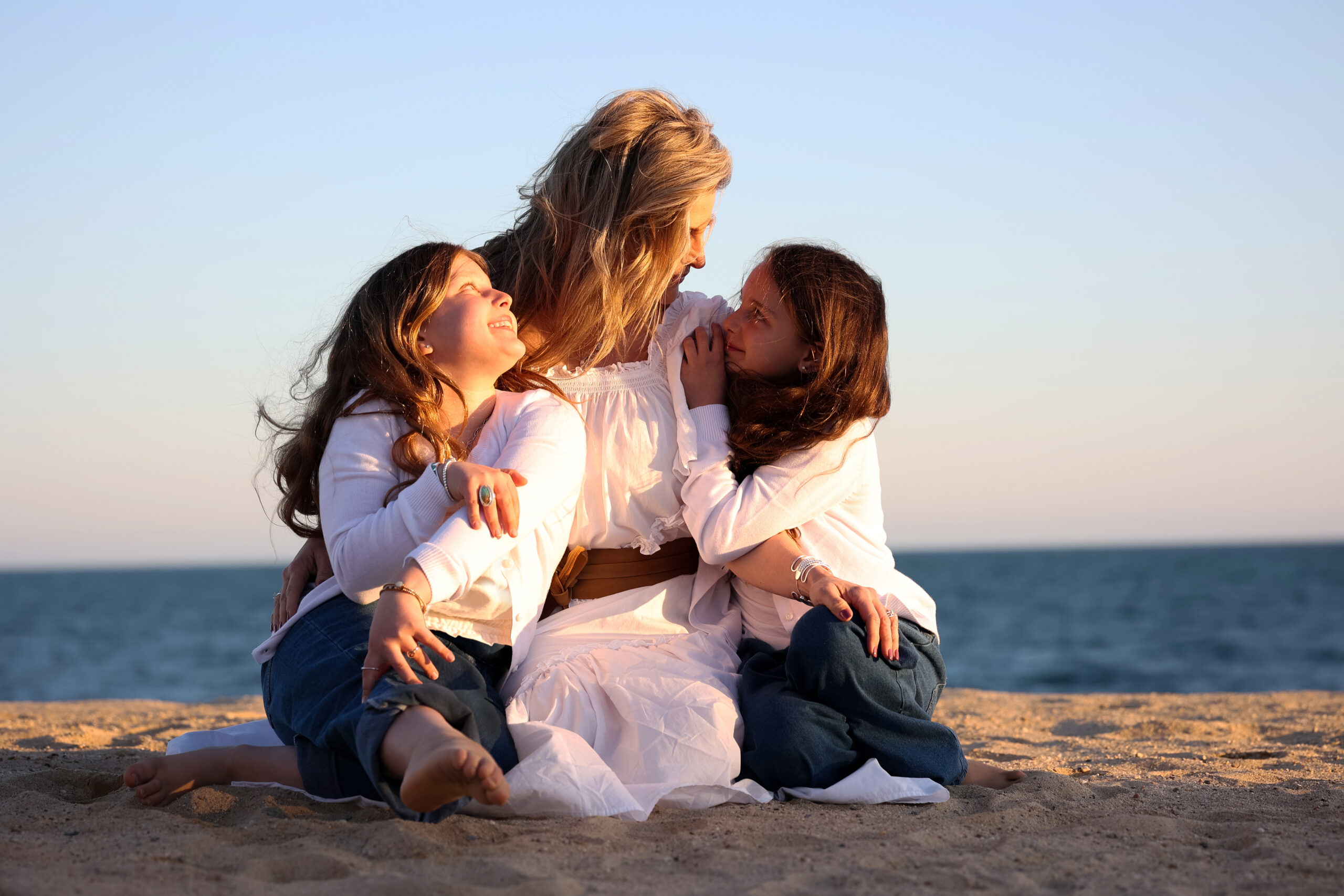 Holly, founder of Dune Jewelry, and her two daughters at Cape Cod beach.