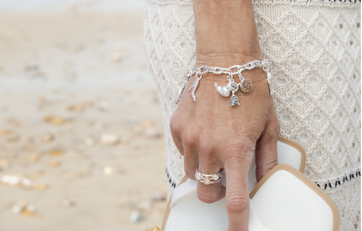 Charm bracelet with Dune Jewelry's Collectible Travel Treasure charms.