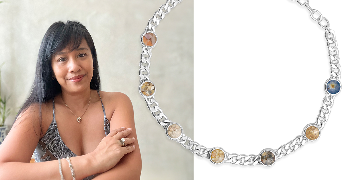 Woman poses in selfie wearing her Traveler Bracelet by Christine Kesteloo, a personalized sterling silver bracelet with sand, shells, and Earth elements from around the world.