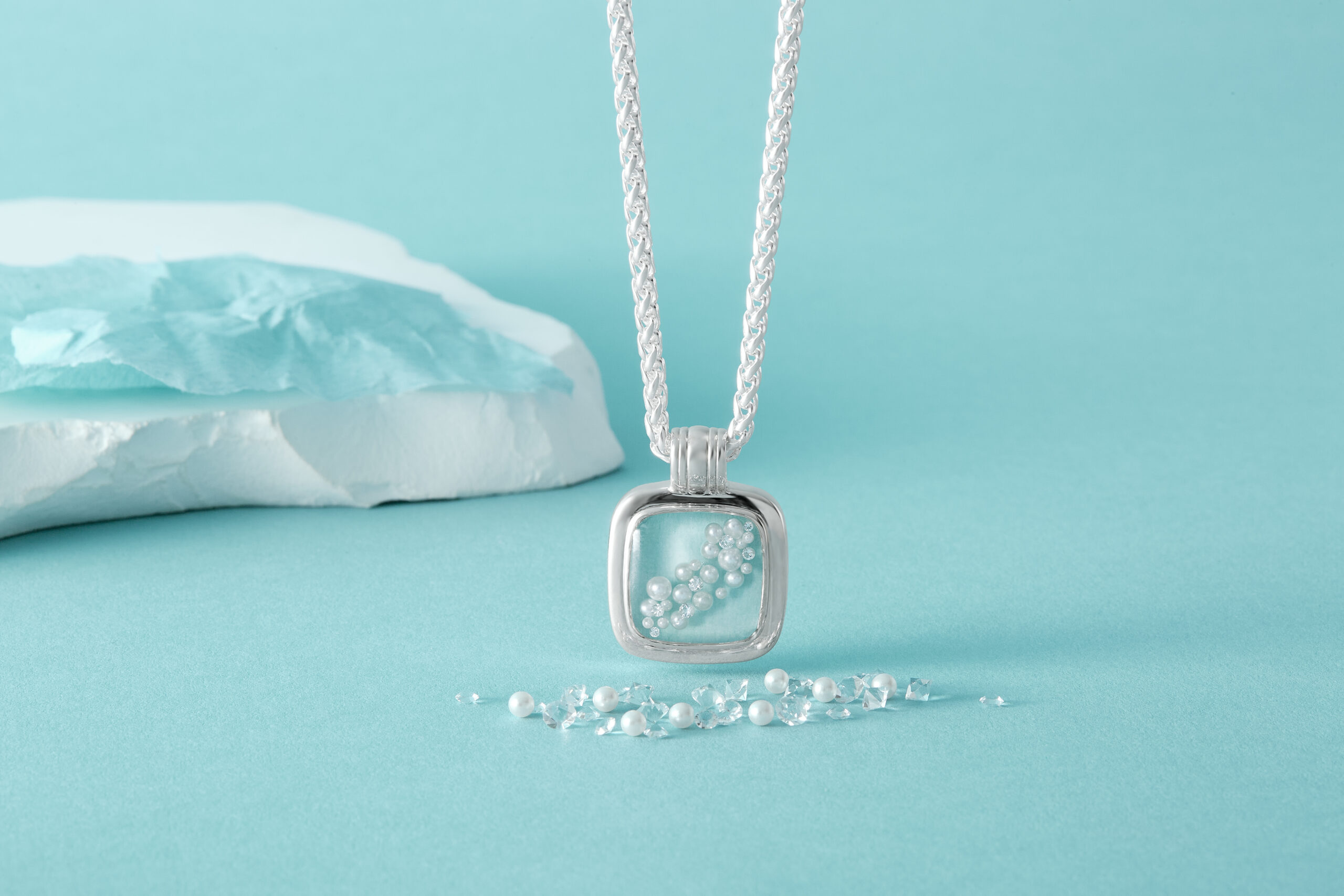 Inspired by Audrey, cinematic and fashion icon, light blue tissue wrapping paper, pearls, and natural diamonds. Pearl necklace and natural necklace. Luxury blue silver necklace.