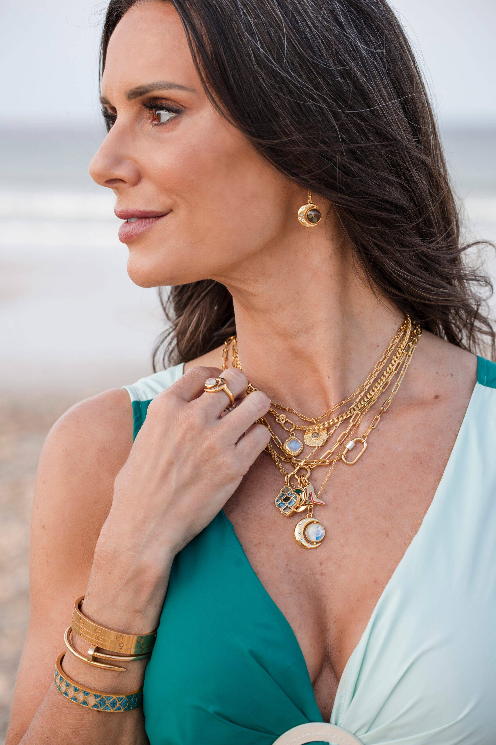 Gold charm necklaces by Captain Kate.