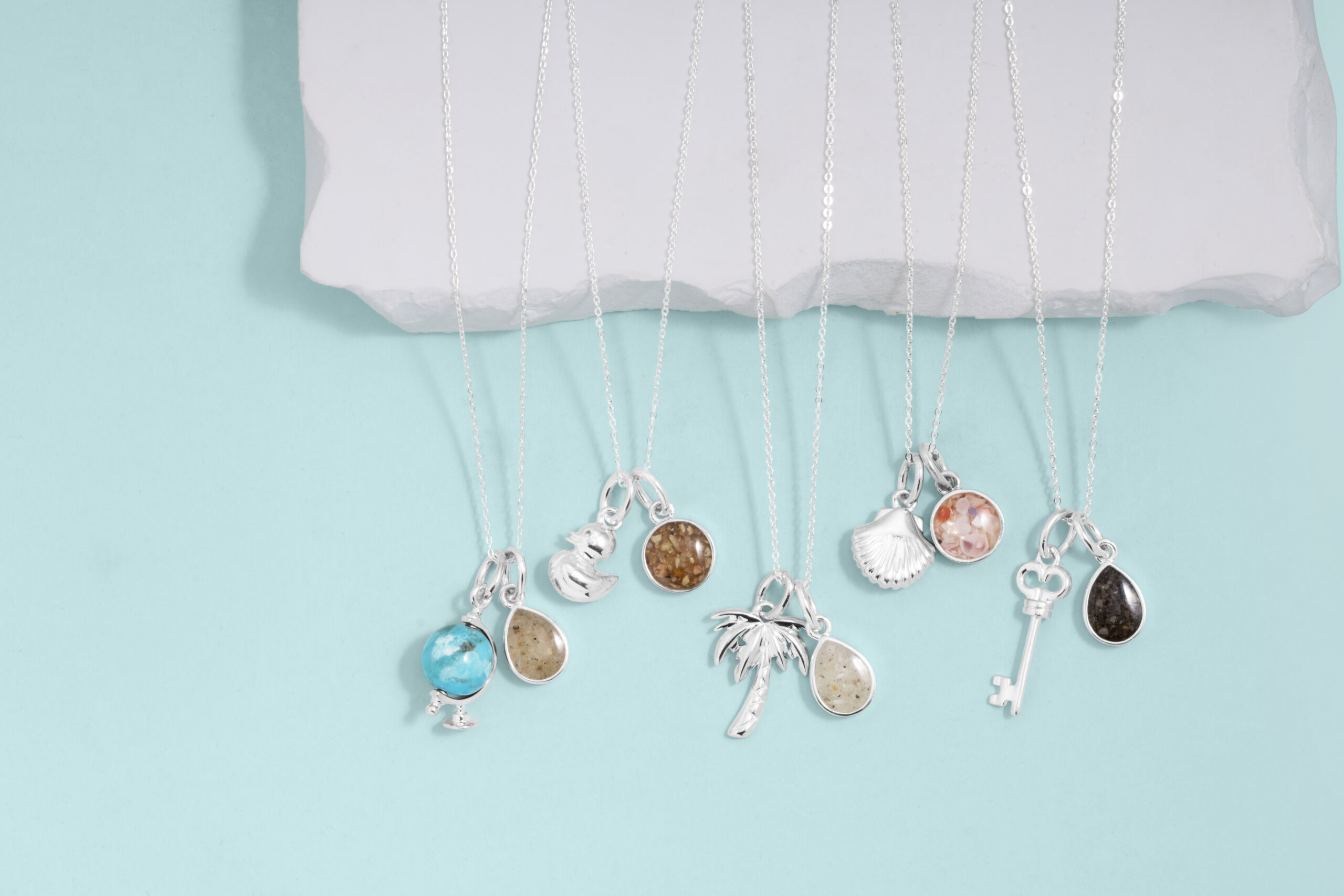 Travel charm bracelet and necklaces.