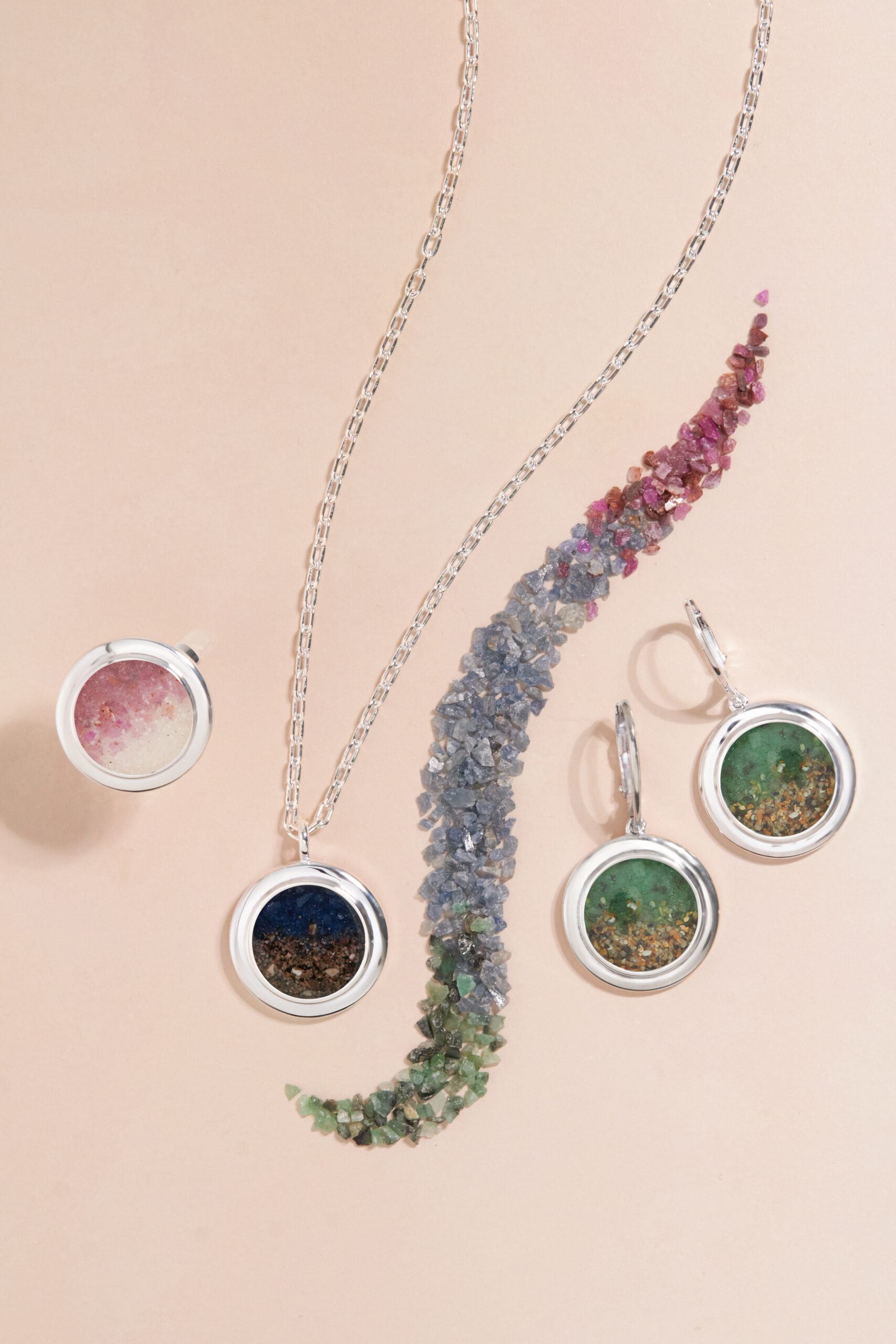 Natural precious gemstone gradients personalized with meaningful sand or earth. Custom Ruby, Emerald and Sapphire gemstone gradient jewelry by Dune Jewelry.