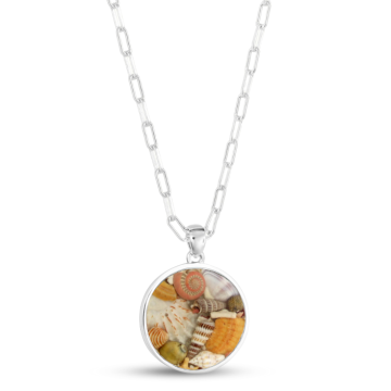 Mediterranean-inspired jewelry featuring a statement sterling silver chain and pendant with ethically sourced shells.