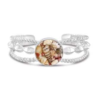 Boho cuff bracelet with three detailed bands, featuring shell fragments in a domed, glass-like finish, embodying coastal bohemian style.