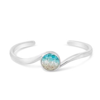 Cuff bracelet handcrafted with sterling silver featuring an ocean wave design, ocean gradient and your choice of sand or element. Great jewelry design for ocean aficionados and beach lovers.