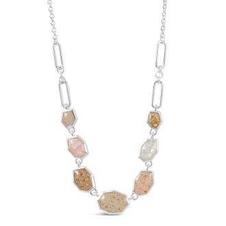 Sterling silver necklace with organic rock-shaped charm, customizable with seven elements for a personalized, travel-inspired jewelry.