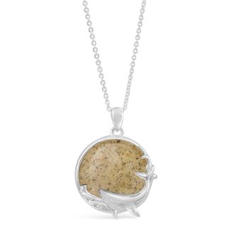 Sterling silver ocean-inspired necklace with a thick cable chain, round shaped pendant with a whale design, and sand and earth elements.