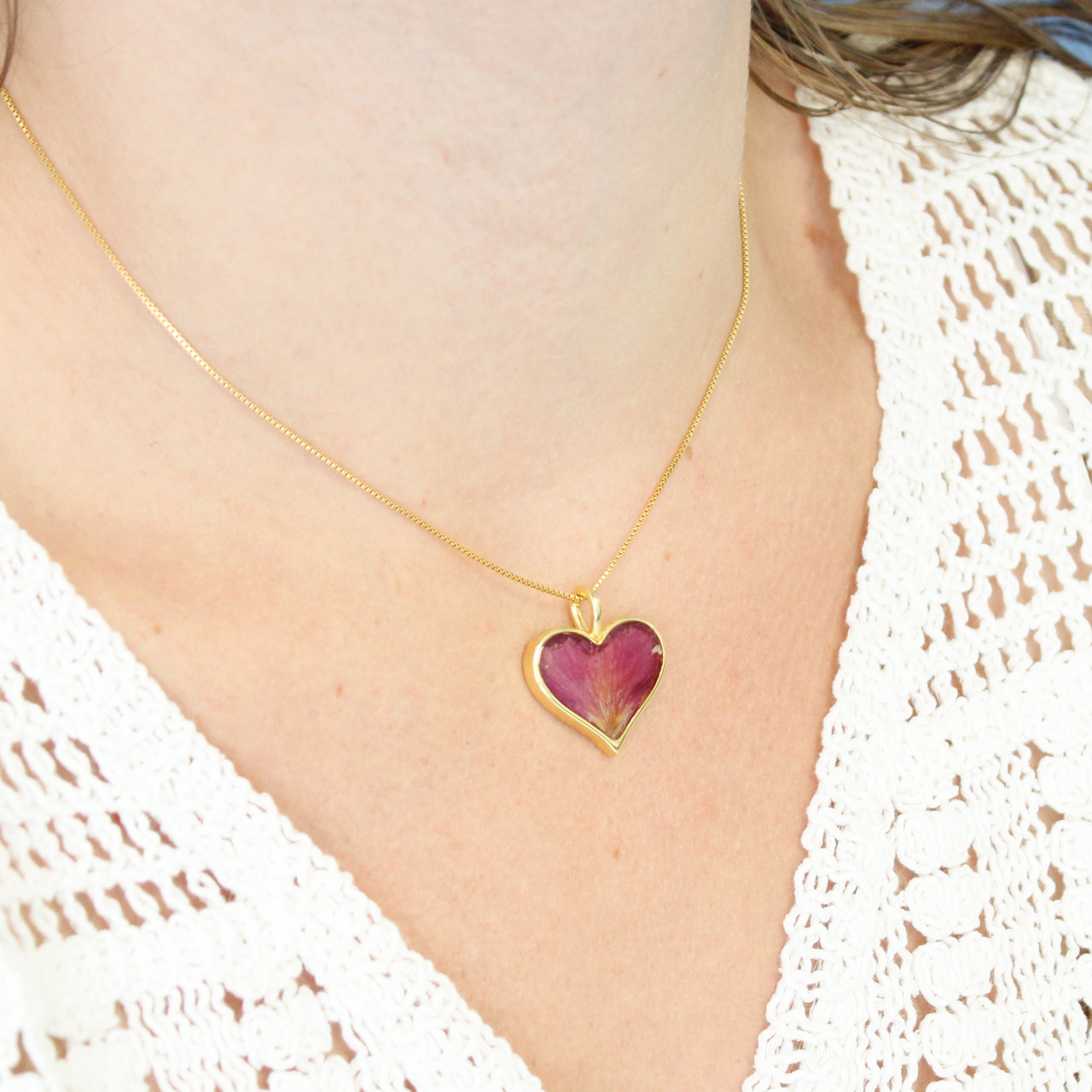 This heartwarming design features a 14k gold vermeil heart handcrafted with an ocean gradient and sand, shells, or earth elements from your favorite location.