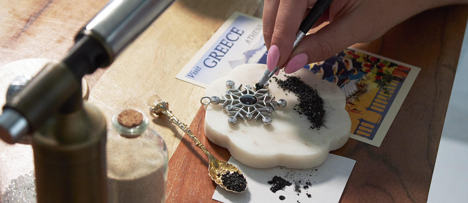Dune artisan handcrafting personalized jewelry with sand and earth elements in the Massachusetts studio.