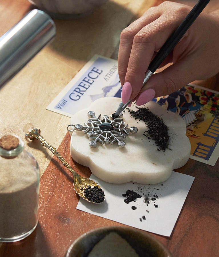 Dune artisan handcrafting personalized jewelry with sand and earth elements in the Massachusetts studio.