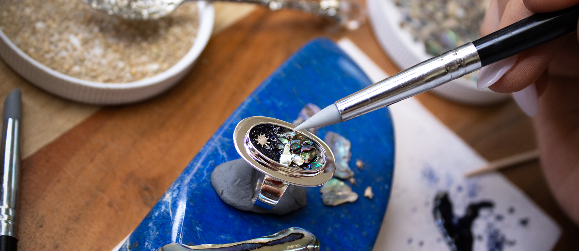 Dune artisan handcrafting personalized jewelry with sand and earth elements in the Massachusetts studio.